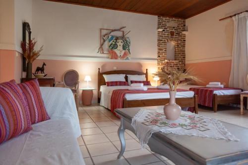 a large bedroom with two beds and a couch at AMNISIADES APARTMENTS in Karteros