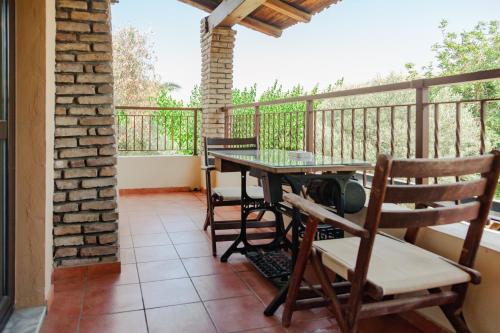 a patio with a table and chairs on a balcony at AMNISIADES APARTMENTS in Karteros