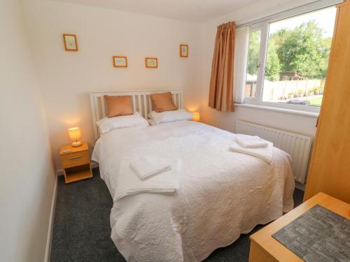 a bedroom with a large bed and a window at Craggy View in Kendal