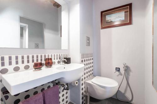 a white bathroom with a sink and a toilet at Magnifica residenza a Manciano - Terme di Saturnia in Manciano