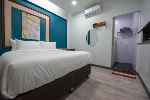 a bedroom with a large bed and a walk in shower at SkyLink Homes in Bangkok