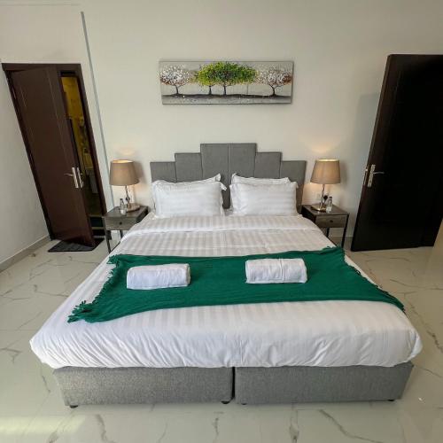 a bedroom with a large bed with two towels on it at The Red Sea Apartment شقة البحر الأحمر in Jeddah