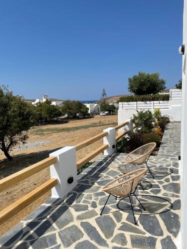 a patio with two chairs and a fence at Serenity Apartment in Engares