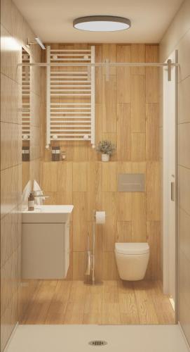 a bathroom with a toilet and a sink at Plac Wolności 6 z klimatyzacją in Poznań