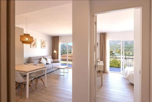 a living room and dining room with a couch and a table at Martinez Apartments in Palmanova
