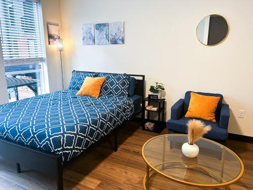 a living room with a couch and a glass table at Ballpark Spruce Studio in Saint Louis