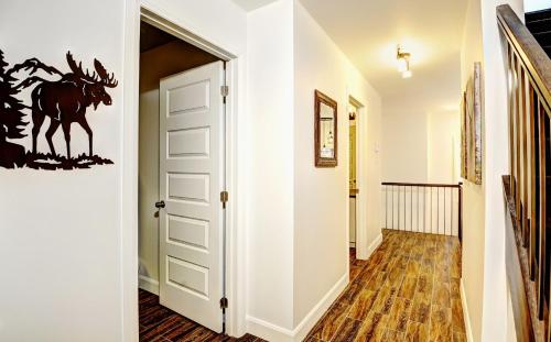 a hallway with a door with a horse stencil on the wall at Chalet 23 Chemin des Quarante by Les Chalets Alpins in Stoneham