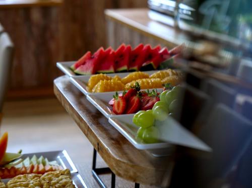 a buffet with plates of fruit on a table at Hotel Eureka in Sopot