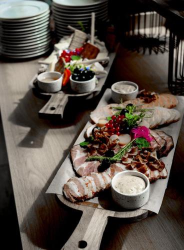 a long table with many plates of food on it at Hotel Eureka in Sopot