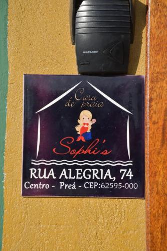 a book with a graduation label on a wall at Casa Sophis Hospedaria Praia do Preá in Prea