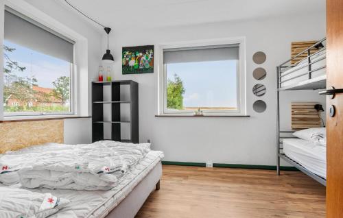 a bedroom with two beds and a bunk bed at 2 Bedroom Stunning Home In Vrå in Vrå