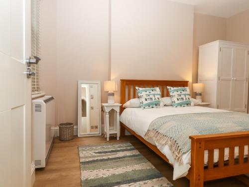 a bedroom with a large bed with blue pillows at 1 Sea Otter House in Teignmouth
