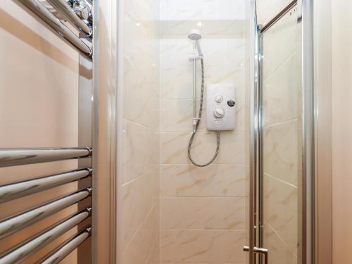 a shower in a bathroom with a glass door at 1 Sea Otter House in Teignmouth