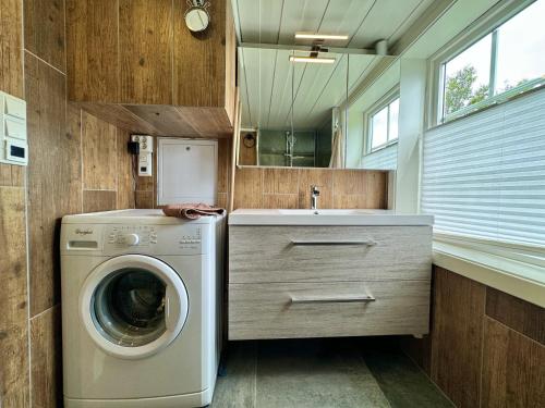 a laundry room with a washing machine and a sink at Cozy, well-equipped and family-friendly cabin in Geilo in Geilo