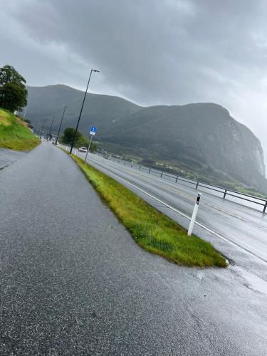 an empty road with a street light on the side of the road at Husslåttene apartments with terrace in Skei 
