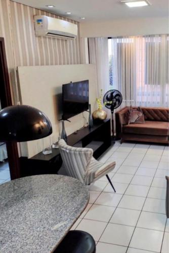 a living room with a couch and a table at Flat 203 Ed Clarice Lispector, Ilhotas- Rio Poty in Teresina