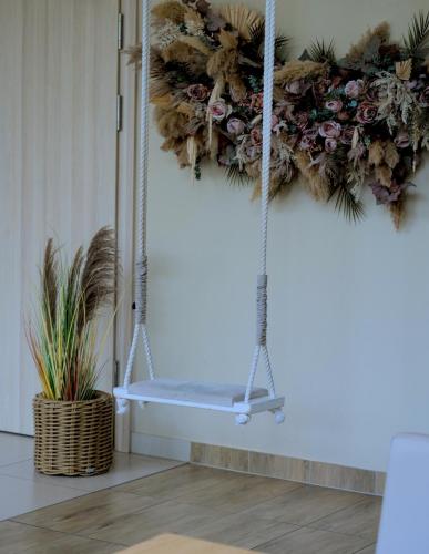 a swing in a room with flowers on the wall at Hotel Eureka in Sopot