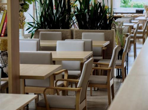 a row of tables and chairs in a restaurant at Hotel Eureka in Sopot