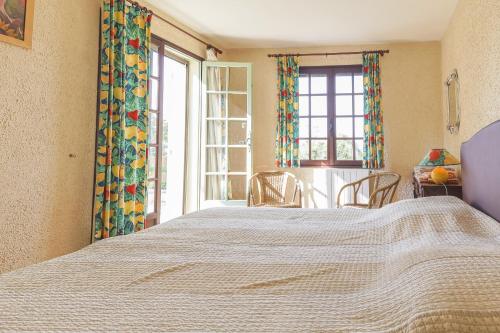 a bedroom with a large bed and a window at Les Oliviers in Saint-Maximin