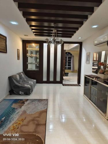 a large living room with a chandelier and a lobby at Ulfah Mersing الفة in Mersing