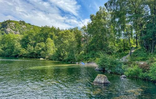 a river with a rock in the middle of it at 4 Bedroom Amazing Home In Lindesnes in Eigeland