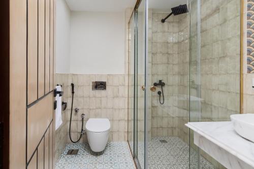 a bathroom with a shower and a toilet and a sink at Fancy Pyramids View Khan Giza's Gem in Cairo
