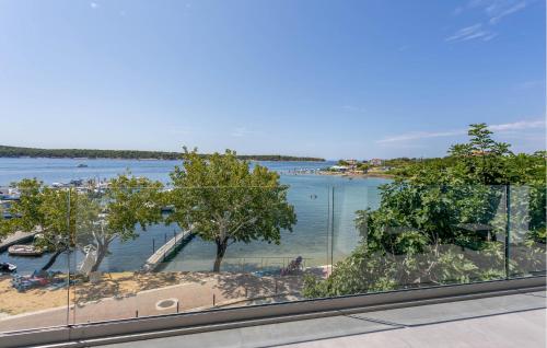 a view of a body of water from a window at Lovely Home In Rab With House Sea View in Rab