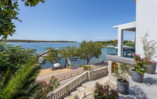 a view of the water from the balcony of a house at Lovely Home In Rab With House Sea View in Rab