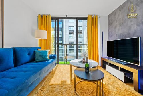 a living room with a blue couch and a tv at 2 Bedroom Greek Street Apartment - Sleeps 6 in Leeds