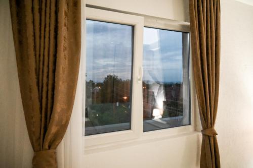 a window with a view of the sky at Apartmani P7 in Dračevo