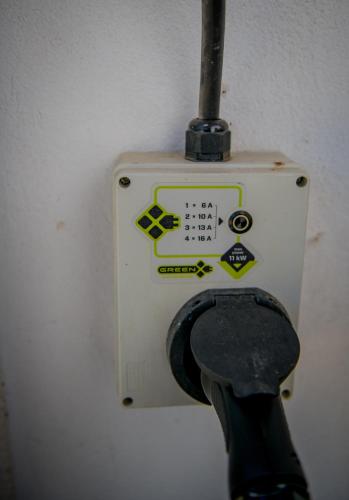 a white switch with a pair of scissors on it at Orgona Vendégház Golop in Golop
