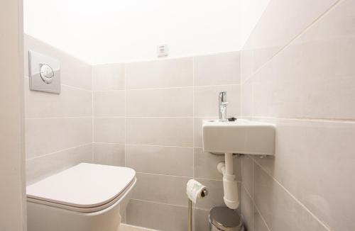 a bathroom with a toilet and a sink at Penzión Max Kežmarok in Kežmarok