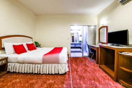 a hotel room with a bed and a desk at Suan Palm Garden View in Rayong
