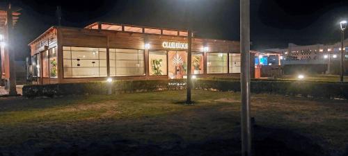 a building at night with lights in front of it at Mountain View Sokhna 1, Villa 4 Bedrooms, Direct to Pool, 300 M to Beach & Dayra Camp, Families ONLY in Ain Sokhna