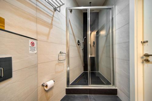 a shower stall with a glass door in a bathroom at Mosta Central City Residences by 360 Estates in Mosta
