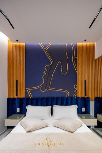 a bedroom with a large bed with a blue headboard at Di Virgilio Suite Luxury in Naples