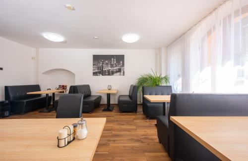 a restaurant with couches and tables and chairs at Penzión Max Kežmarok in Kežmarok