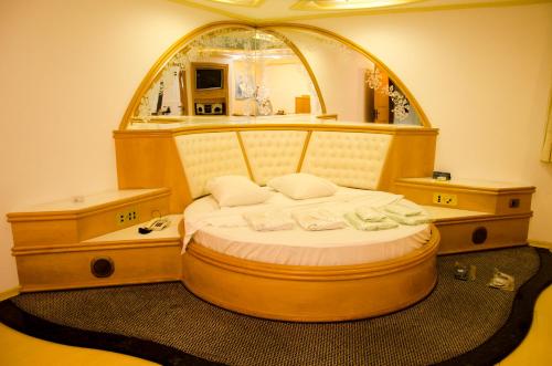 a bed in a room with an arched window at Omega Palace Hotel in Sao Paulo