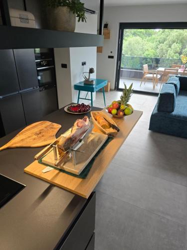 a kitchen with a table with food on it at Penthouse HEDONIST with hidromassage bath in Pula