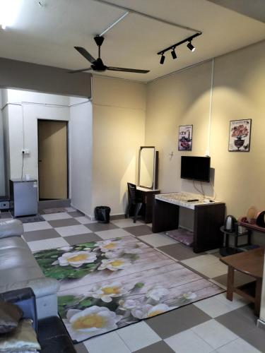 a living room with a couch and a table at Ulfah Mersing الفة in Mersing