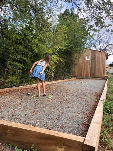 une jeune fille qui fait du skateboard dans une cour dans l'établissement Chambres d'hôtes Mérignac avec jacuzzi privatif pour le studio, à Mérignac