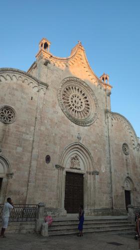 two people standing in front of a church at Casedda Ostunese in Ostuni