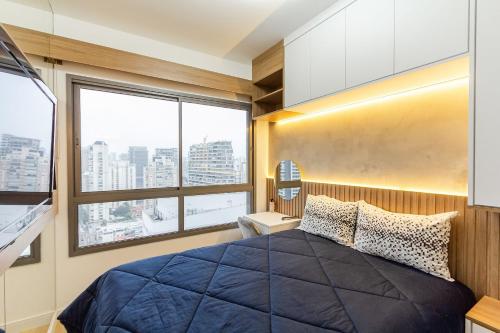 a bedroom with a large bed and a large window at Vista Alta/Academia/Insper e Hosp.São Luiz 650mts in Sao Paulo