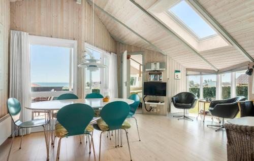 a dining room with a table and chairs at Nice Home In Sjølund With Sauna in Sjølund