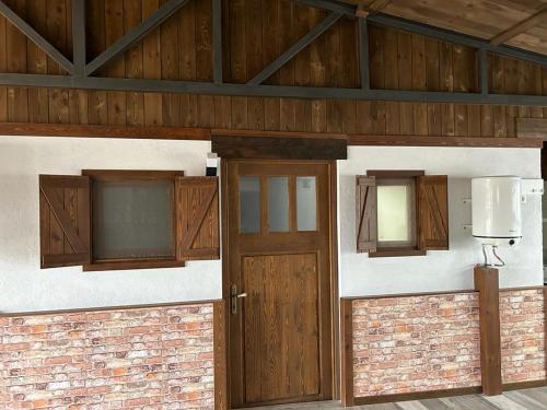 an entrance to a building with wooden doors and windows at Casa Rural en Valera La Egipcia in Valera de Abajo
