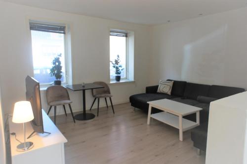 a living room with a couch and a table at 144Nygårdsvej (id.168) in Esbjerg