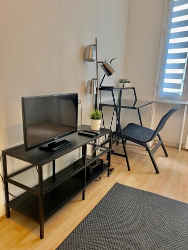 un salon avec une télévision et une chaise dans l'établissement Le Châteaudun Thabor Centre ville, à Rennes