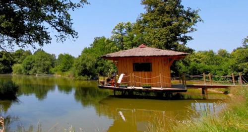 a small hut in the middle of a lake at Le Domaine de la Vergnolle in Roches