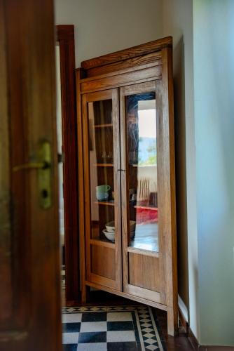 a wooden cabinet in the corner of a room at La Casa del Conte in Cerreto