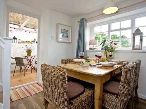 a dining room with a wooden table and chairs at Oyster Cottage in Cockwood